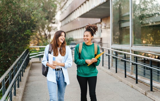 University student girl friends with learning books walking out School building