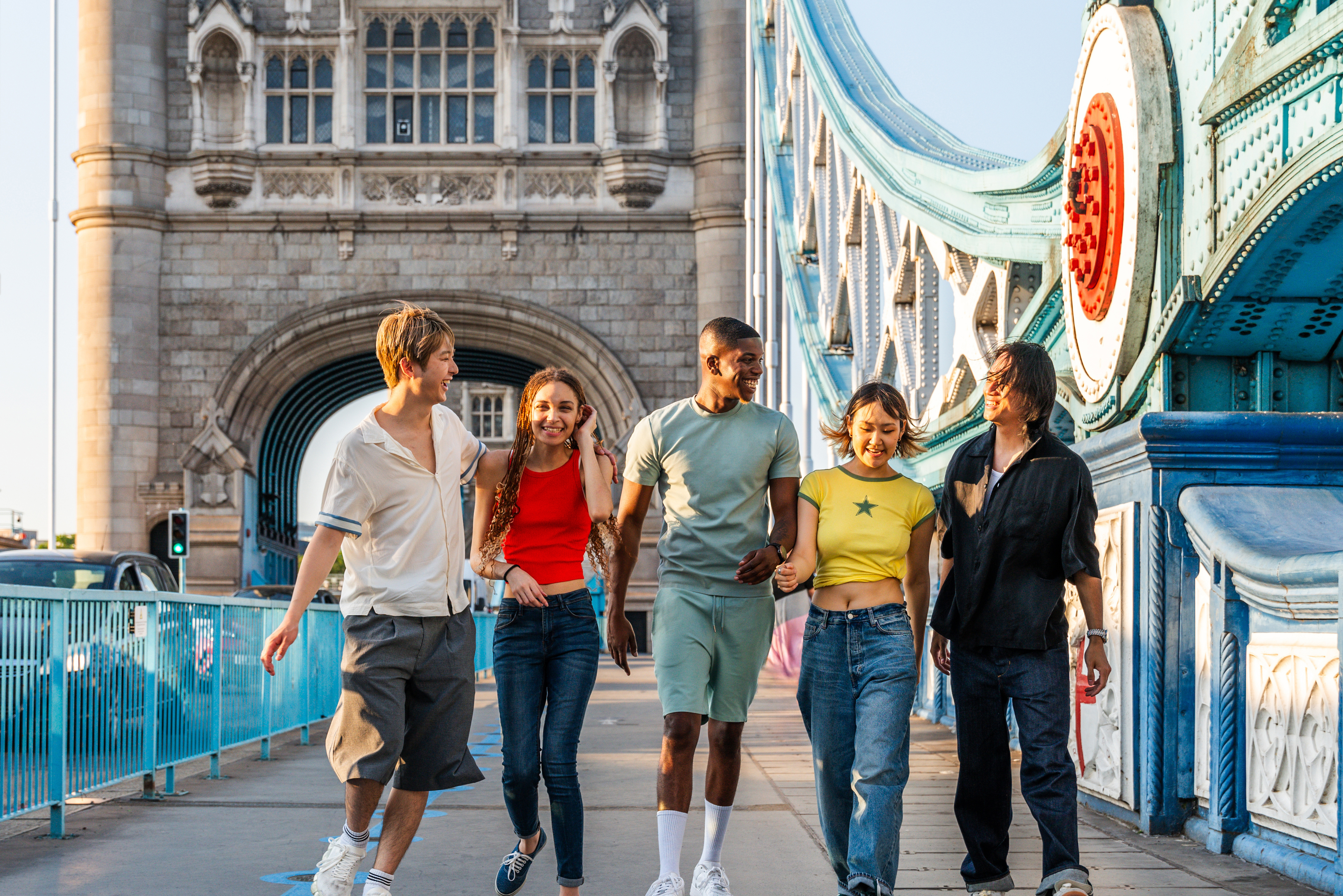 Group of young international students crossing Tower Bridge in London