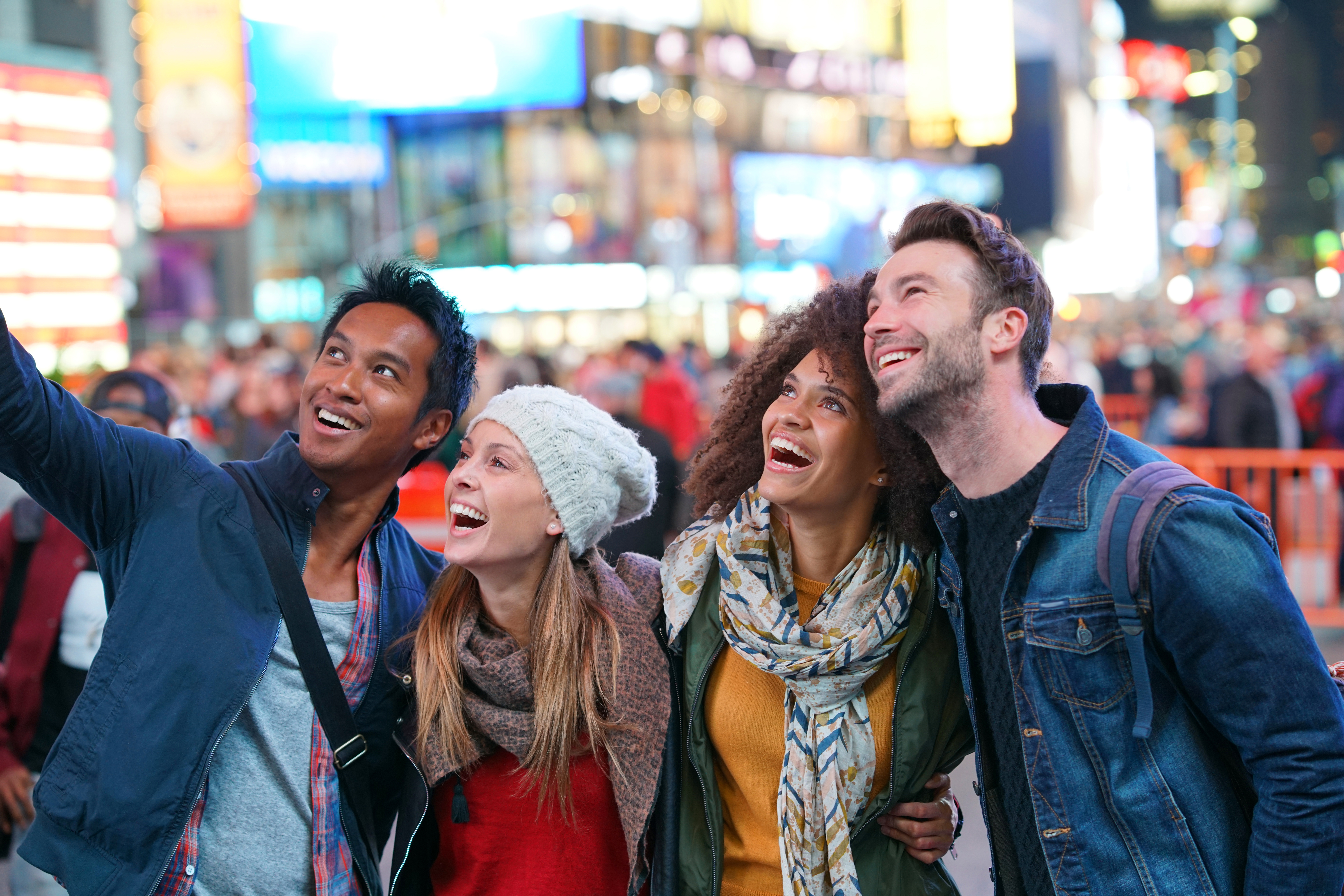 Group of friends having fun and holding each other at Times Square, New York City