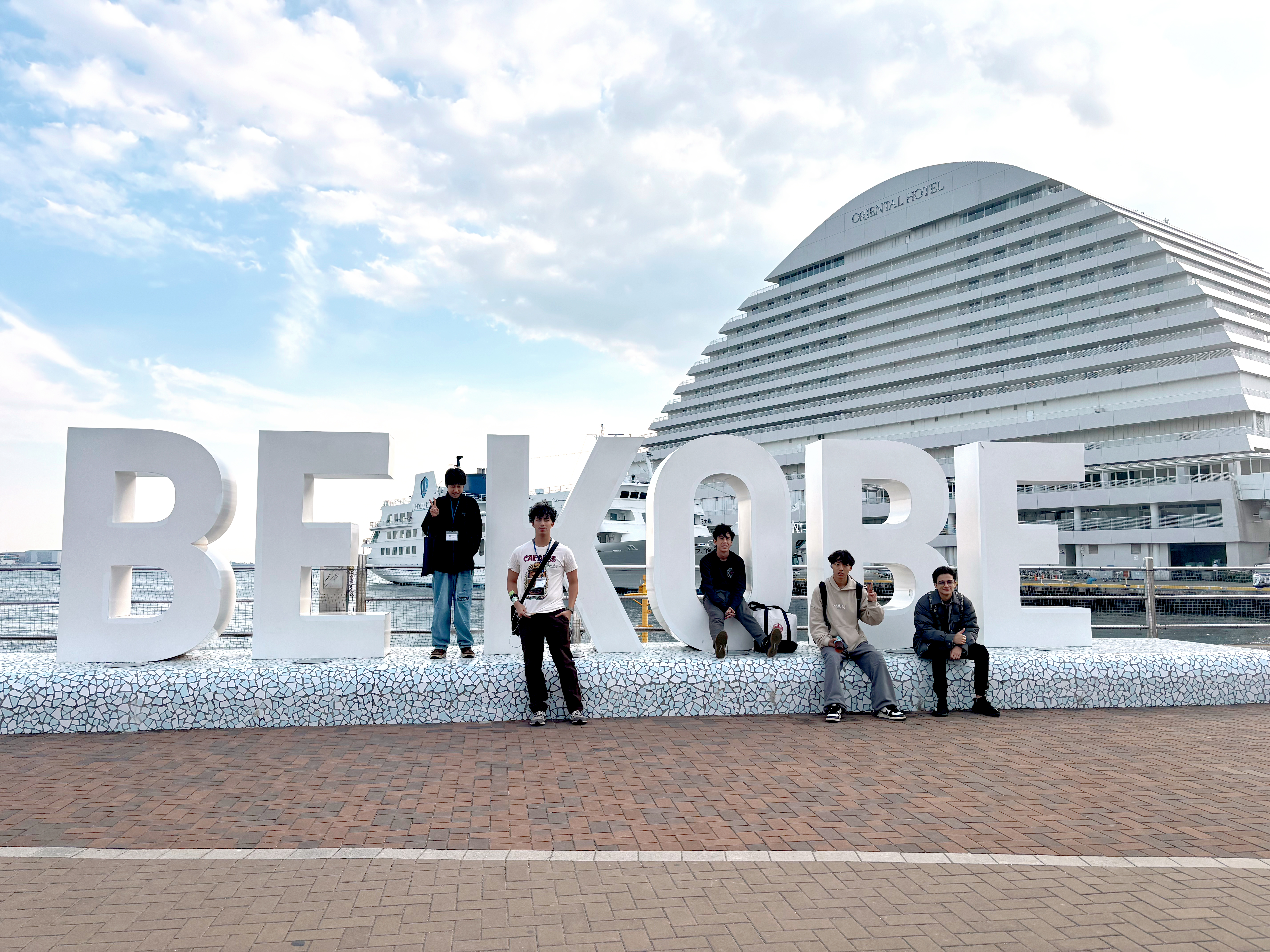 A group of students at the Kobe sign