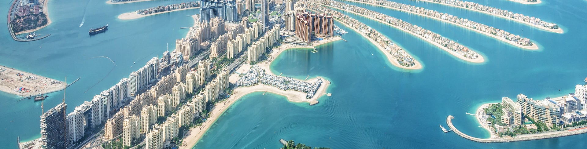 Aerial view of Dubai surrounded by Persian Gulf waters and with modern skyscrapers