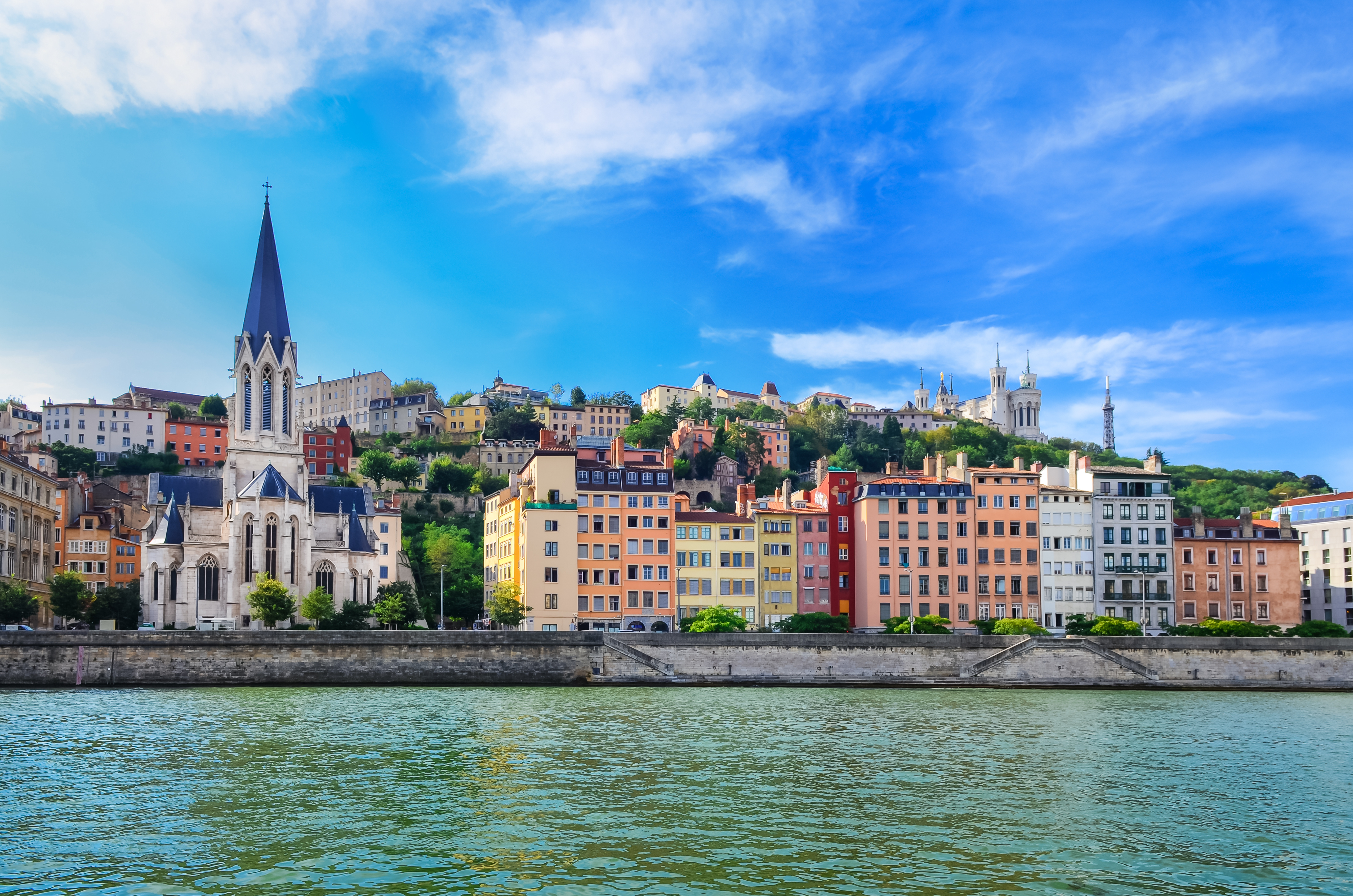 Historic Église Saint-Georges surrounded by colorful riverside buildings in Lyon city center, France