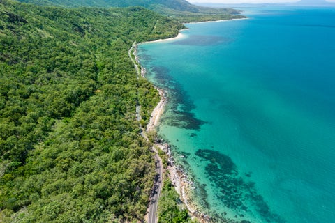 "Aerial view of Cairns Desert Beach, Australia, with sandy shore and blue water