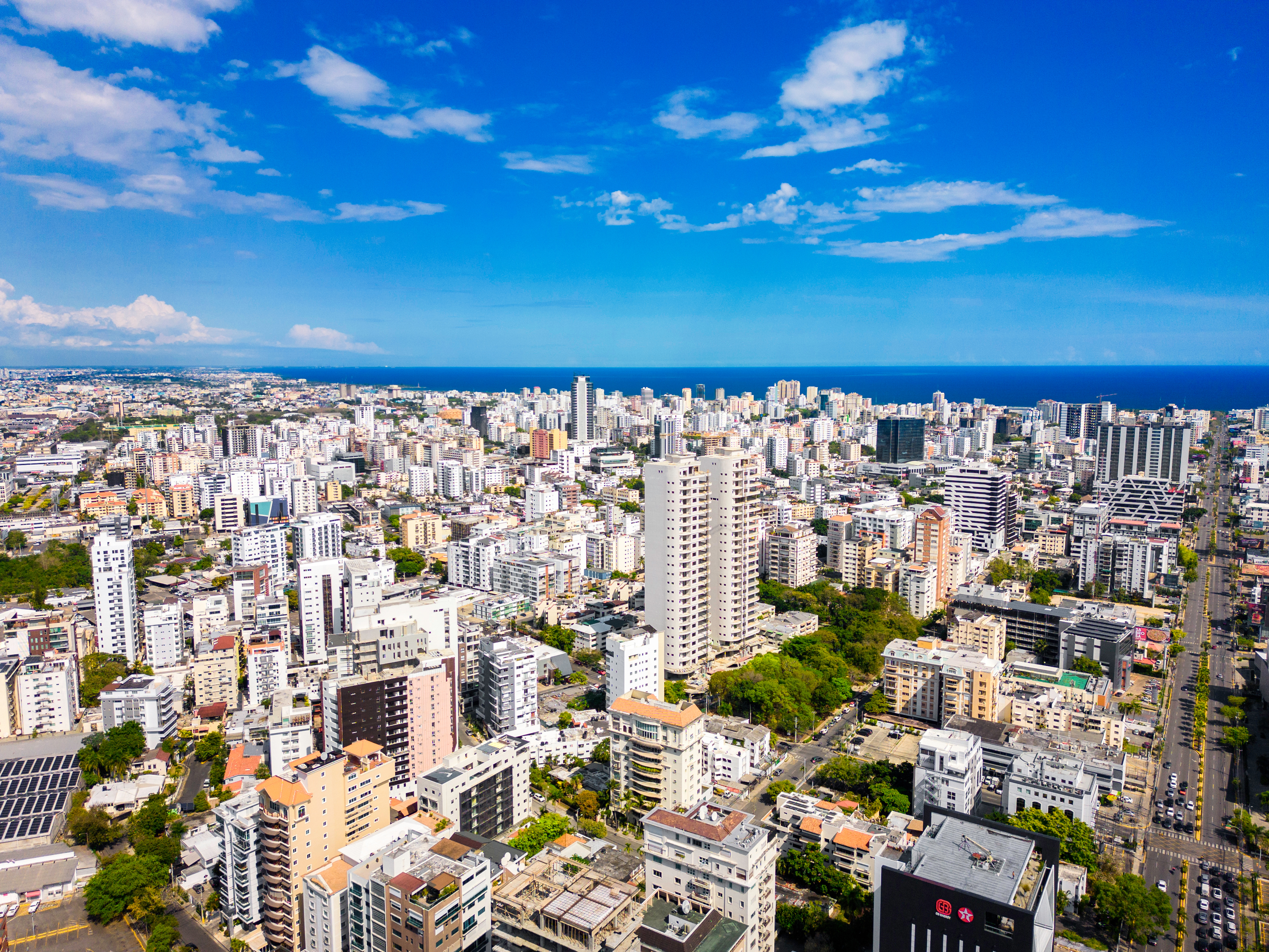 Aerial view of Santo Domingo, Dominican Republic, with modern buildings and the Caribbean Sea in the background