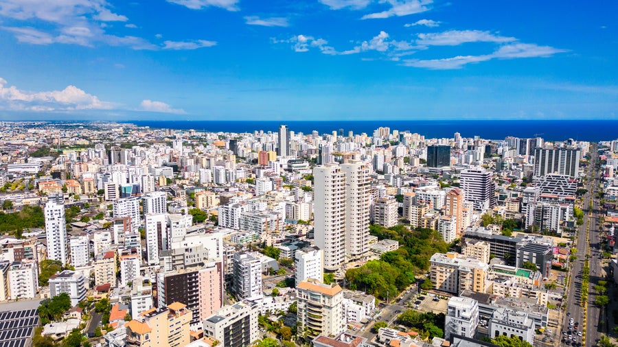 Aerial view of Santo Domingo, Dominican Republic, with modern buildings and the Caribbean Sea in the background