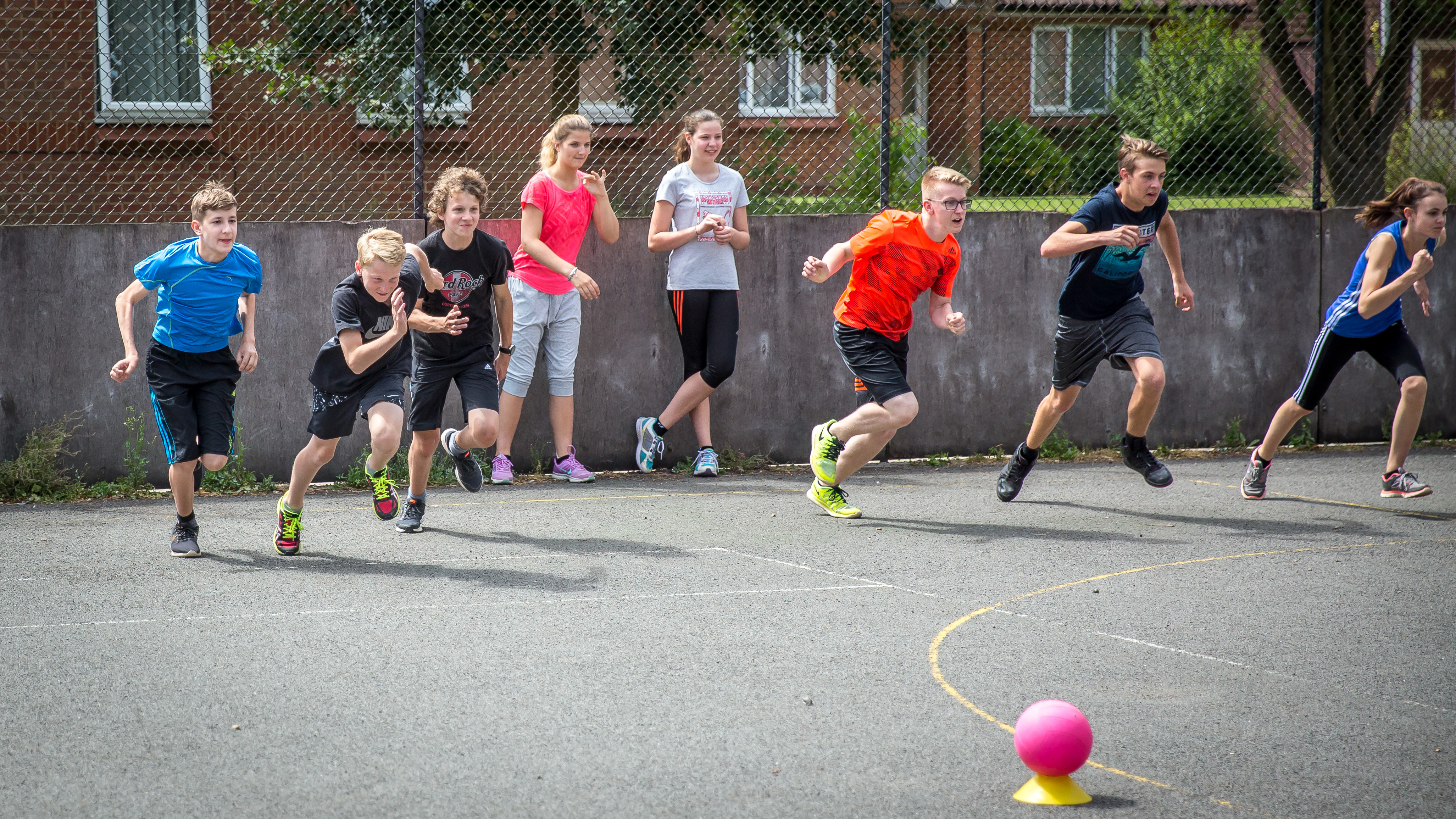 Students playing outside with a ball