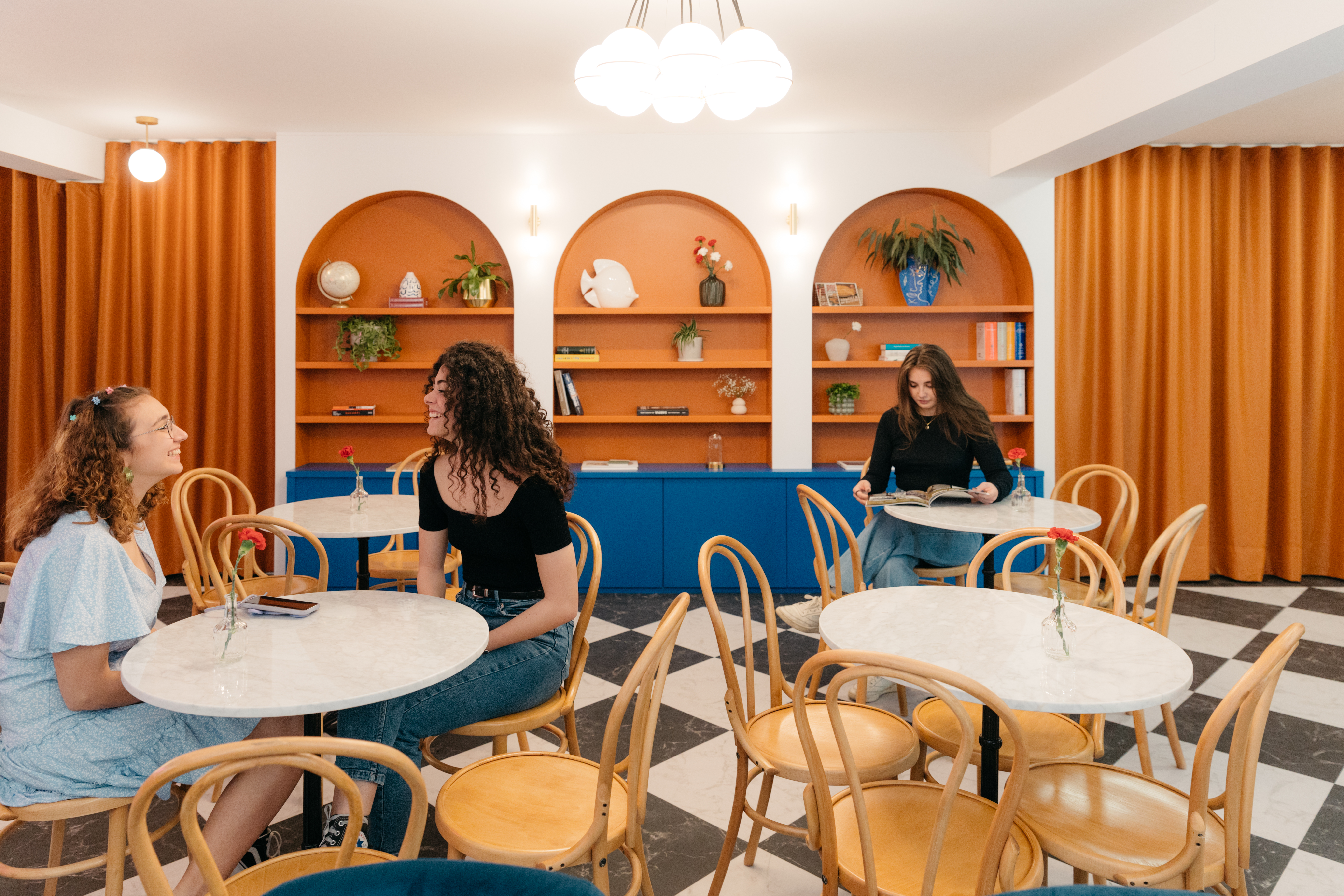A few students sitting in the common area