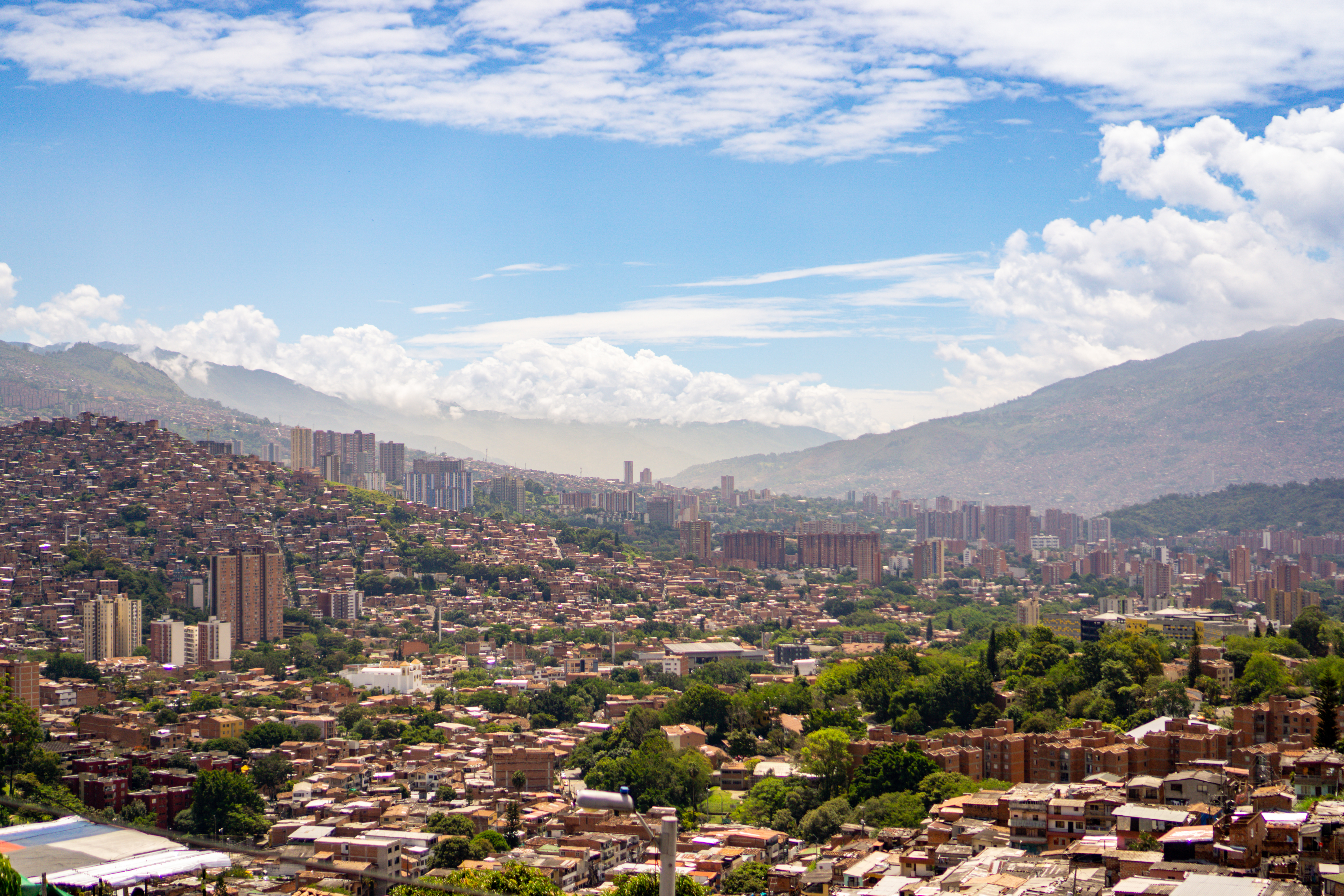 An aerial view of Medellín City, Antioquia, Colombia, reveals a vibrant urban landscape nestled within the Aburrá Valley