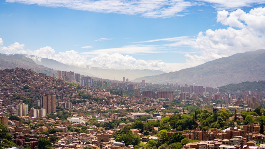 An aerial view of Medellín City, Antioquia, Colombia, reveals a vibrant urban landscape nestled within the Aburrá Valley