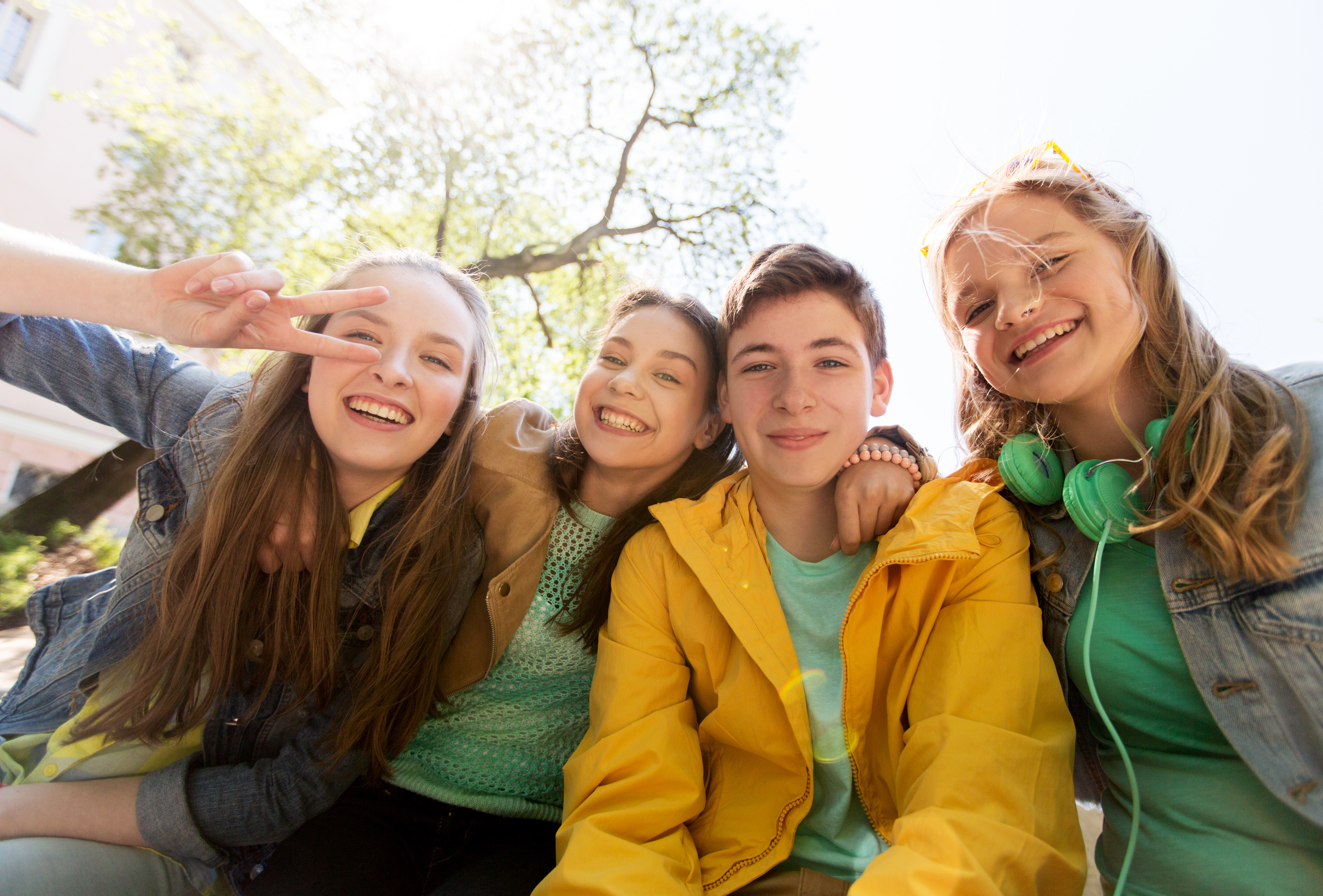 Happy students capturing a selfie moment in school courtyard