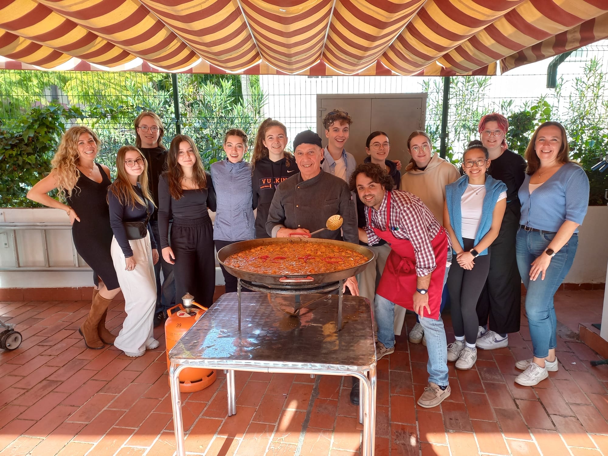 Students cooking paella at the school terrace