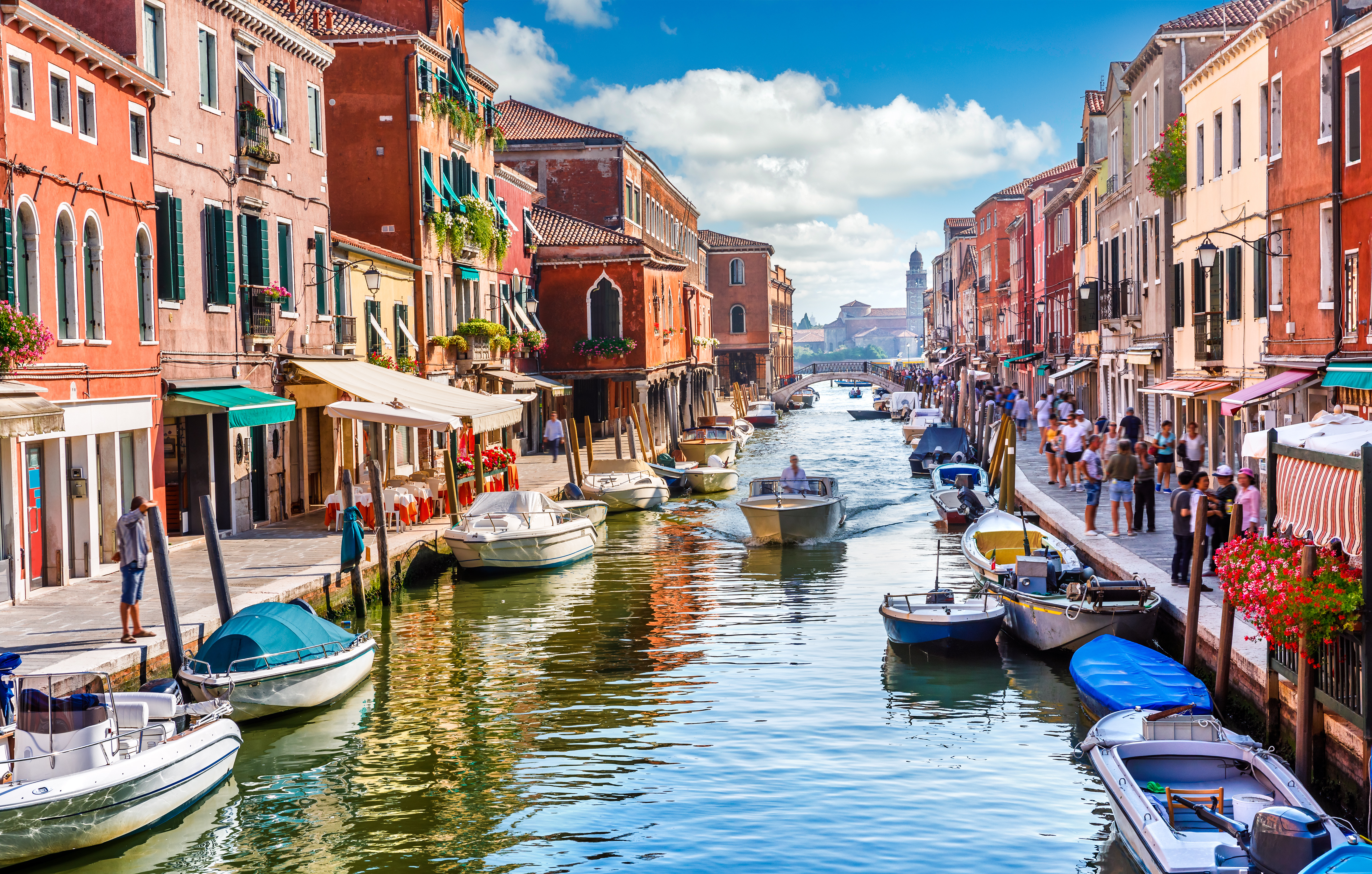 Venice, Italy, featuring boats navigating narrow canals and charming historic streets