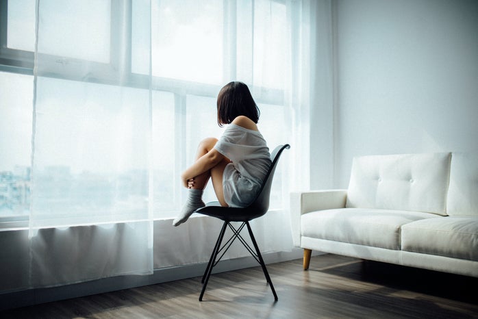 woman sitting alone looking out window by ANTHONY TRAN?width=698&height=466&fit=crop&auto=webp
