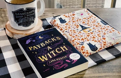 book on table with tea and book sleeve