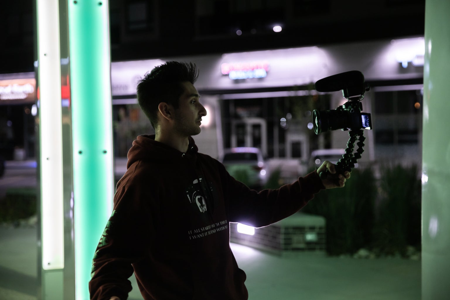 man using camera during night time