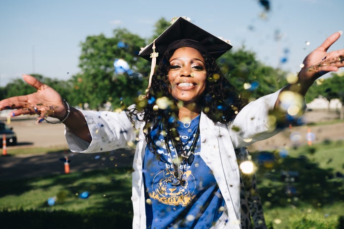 woman graduating throwing confetti