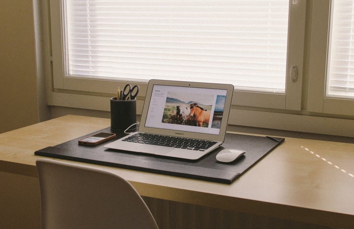 organized desk workspace with laptop and phone