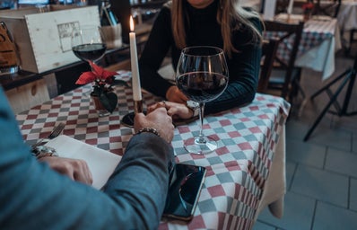 Couple holding hands at dinner table
