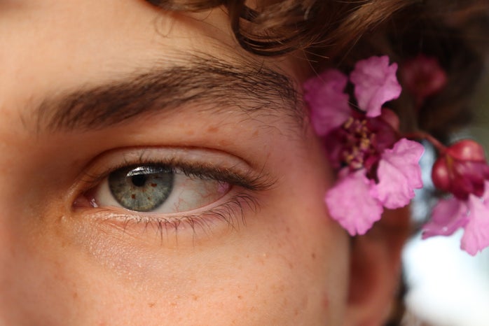 Person, looking off to the side, close-up, flowers