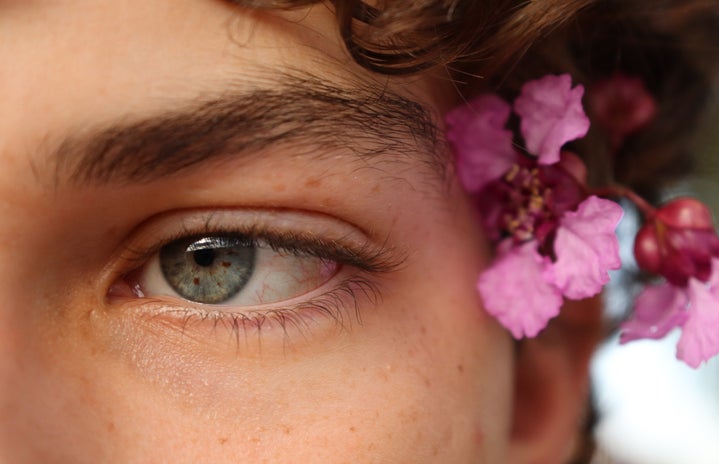 Person, looking off to the side, close-up, flowers