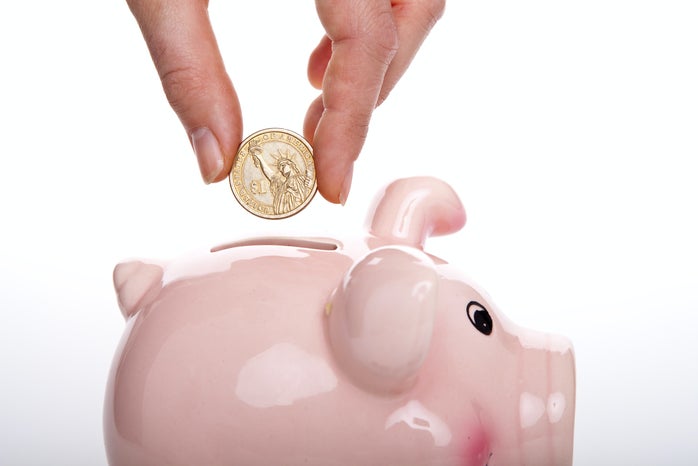 Putting money in a piggy bank by Damir Spanic?width=698&height=466&fit=crop&auto=webp