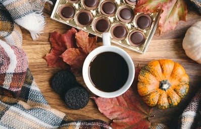 table with coffee, chocolate, blanket, leaves, oreos