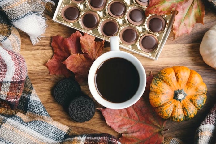 table with coffee, chocolate, blanket, leaves, oreos