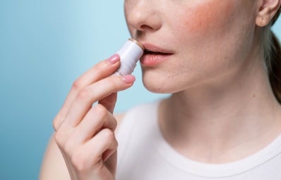 Woman applying lip balm