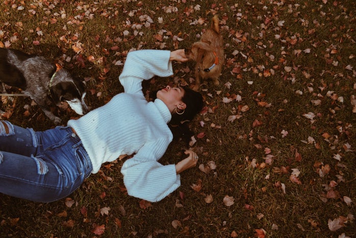 woman lying on ground with leaves