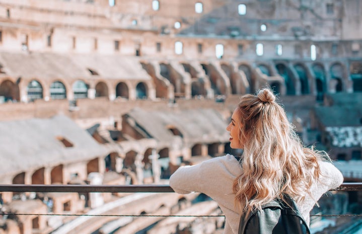 Woman visiting the Colosseum in Rome Italy by Courtney Cook via Unsplash?width=719&height=464&fit=crop&auto=webp