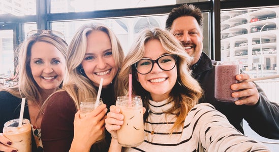selfie of 4 people with coffees and one smoothie