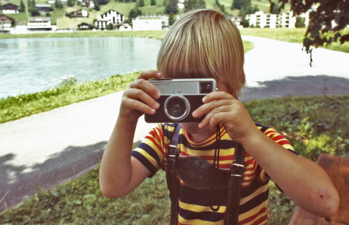 blonde boy with vintage camera