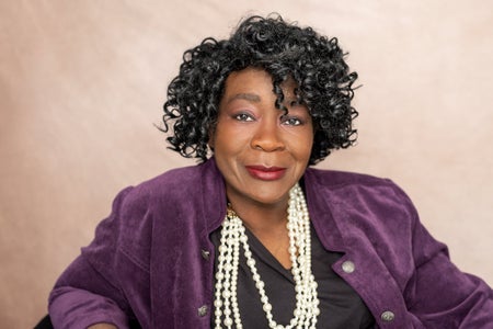 Vicki Webb headshot with big pearl necklace