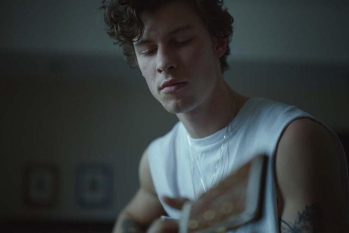 An image of Shawn Mendes playing guitar