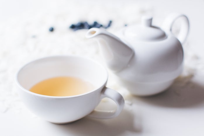 Tea pot with cup of tea