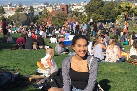 Woman at the park sitting down on the grass