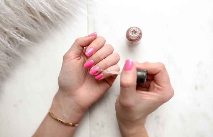 woman painting nails with pink polish by Element5 Digital?width=719&height=464&fit=crop&auto=webp