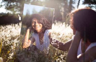 Reflection of woman smiling in the mirror