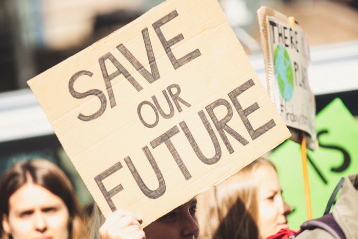 Woman holding \"Save Our Future\" sign