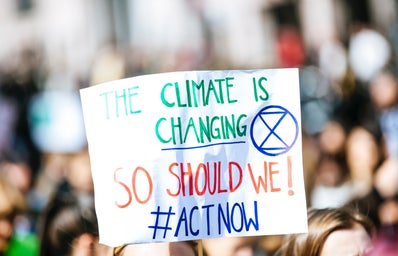 person holding a climate change protest sign