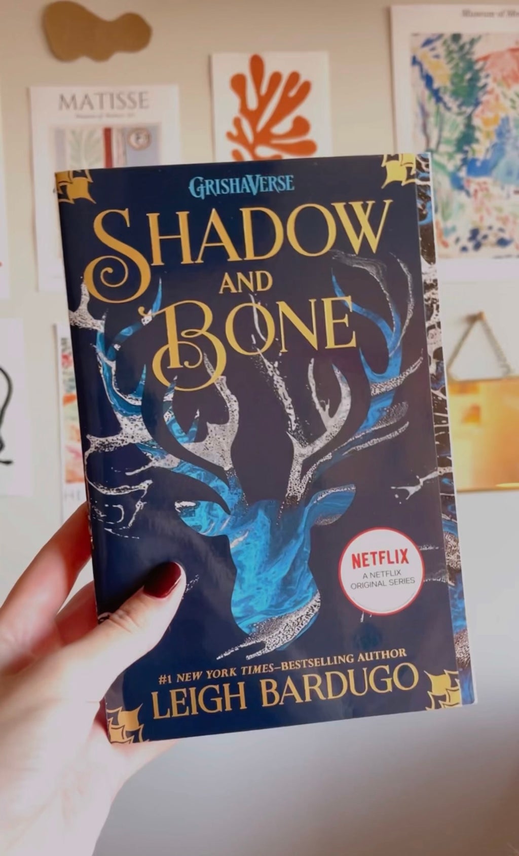 Photo of hand holding book. Shadow and Bone.
