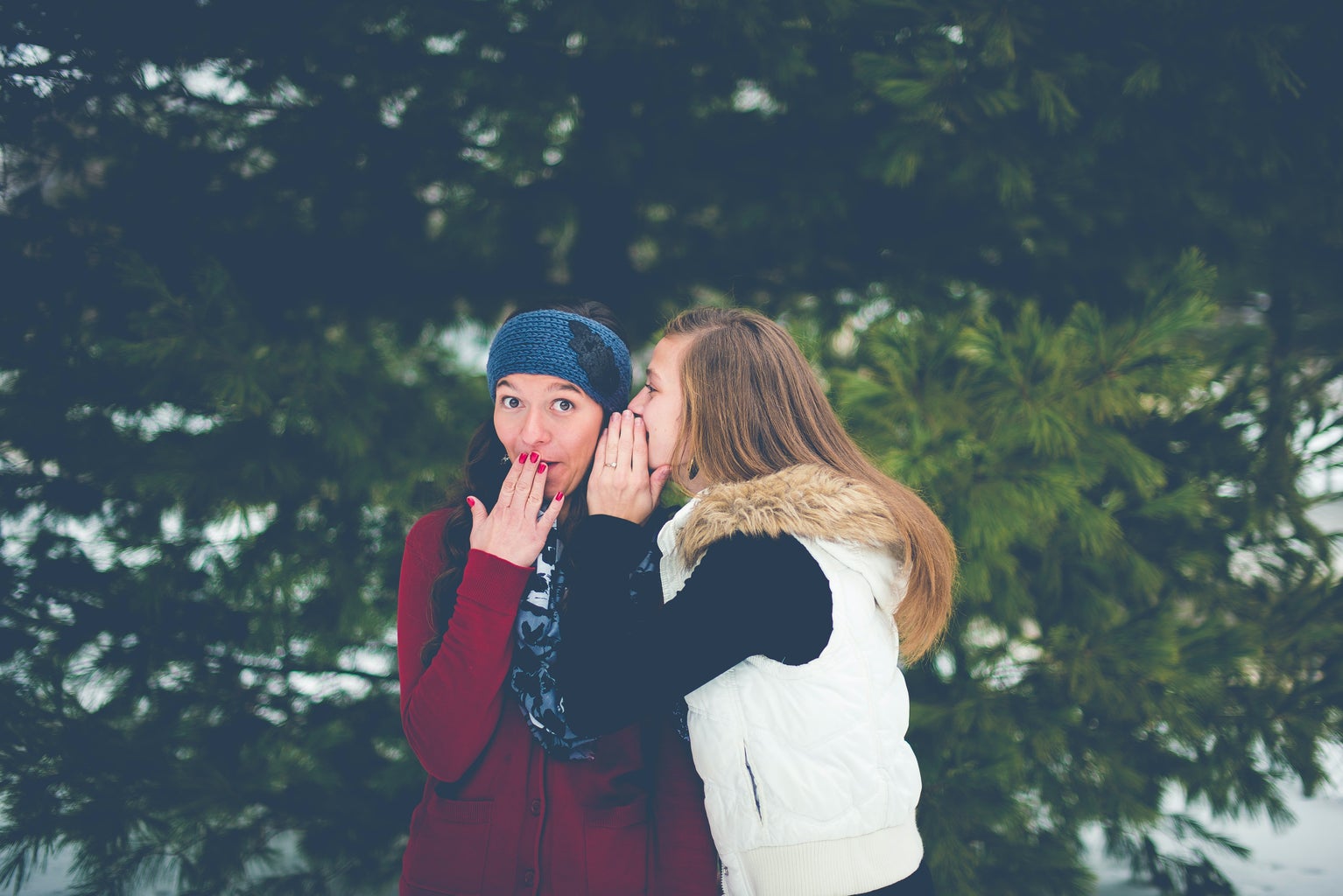 image of two women whispering