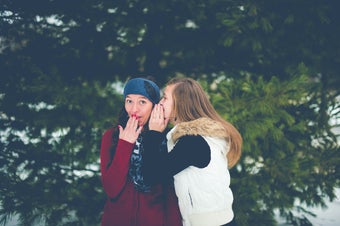 image of two women whispering