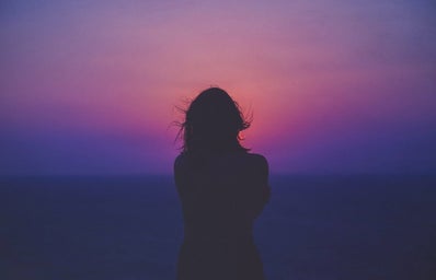Girl in front of sunset