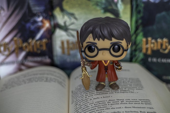 harry potter figurine standing on book
