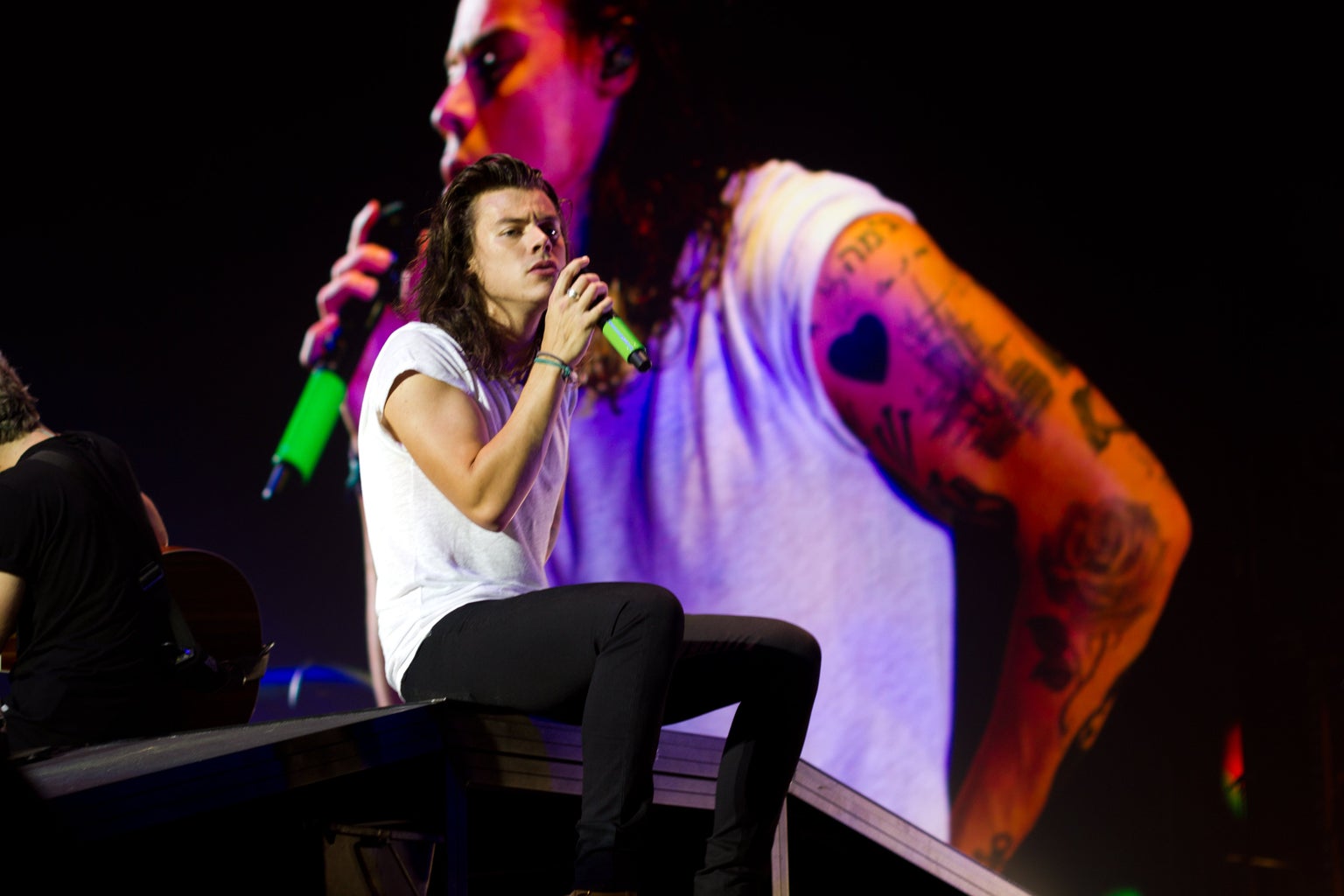 Harry Styles singing on stage