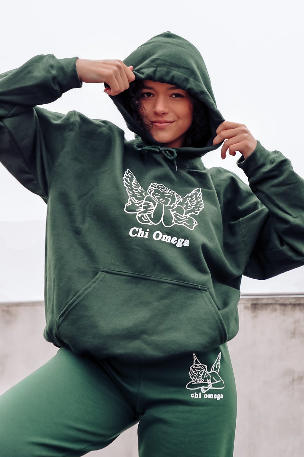 girl posing in green sweatshirt