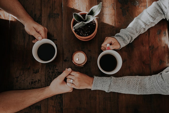 Couple holding hands over coffee by Unsplash?width=698&height=466&fit=crop&auto=webp