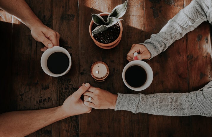 Couple holding hands over coffee by Unsplash?width=719&height=464&fit=crop&auto=webp