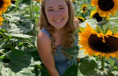 woman smiling with sunflowers